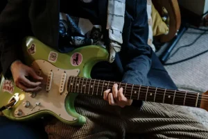 Student speelt gitaar bij de gitaarplaats